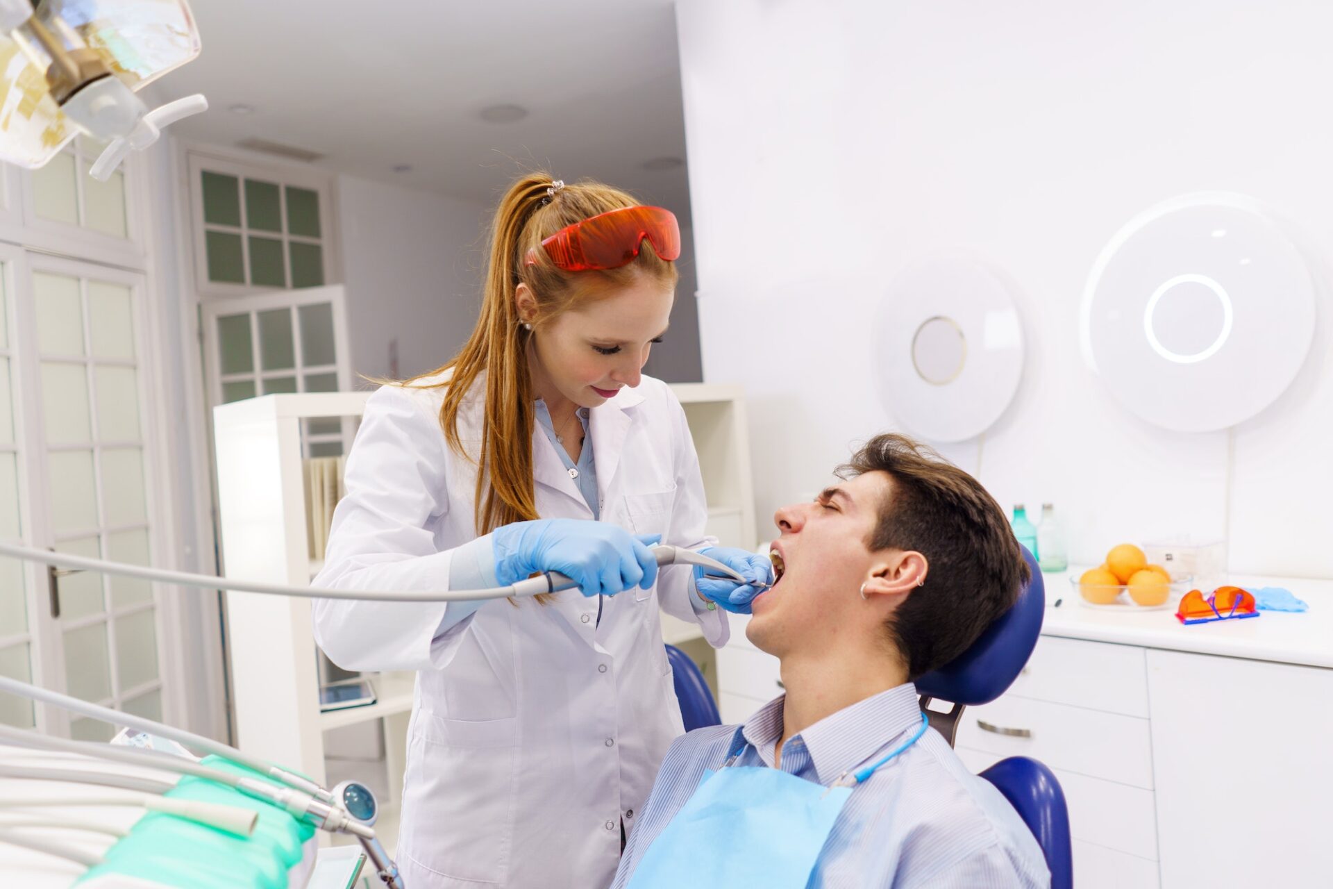 dentist-using-tool-dental-drill-on-patient