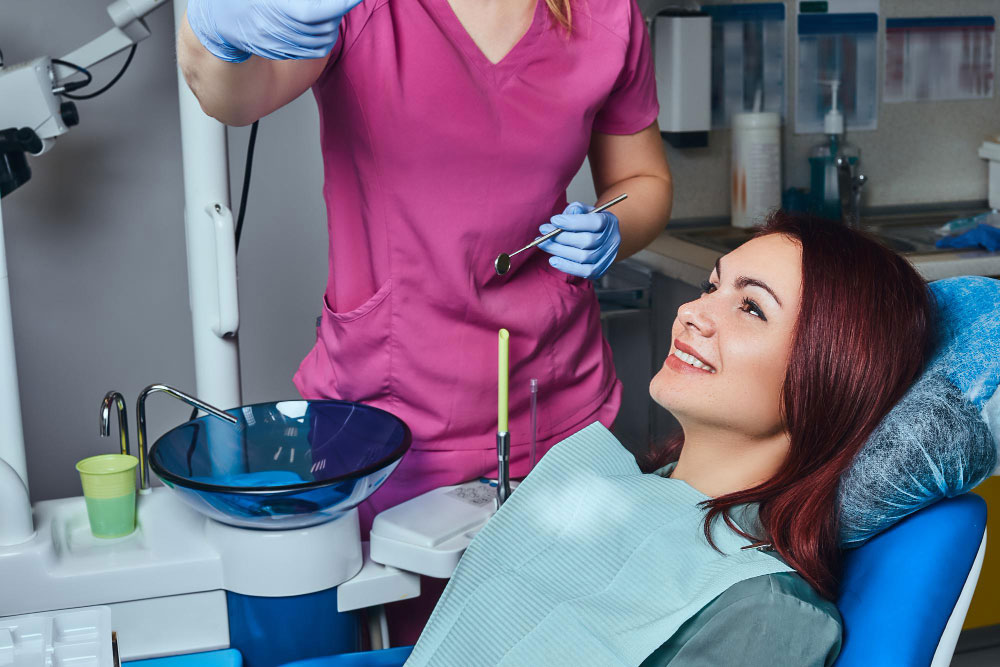 young-redhead-woman-having-examination-while-sitting-dental-chair-clinic